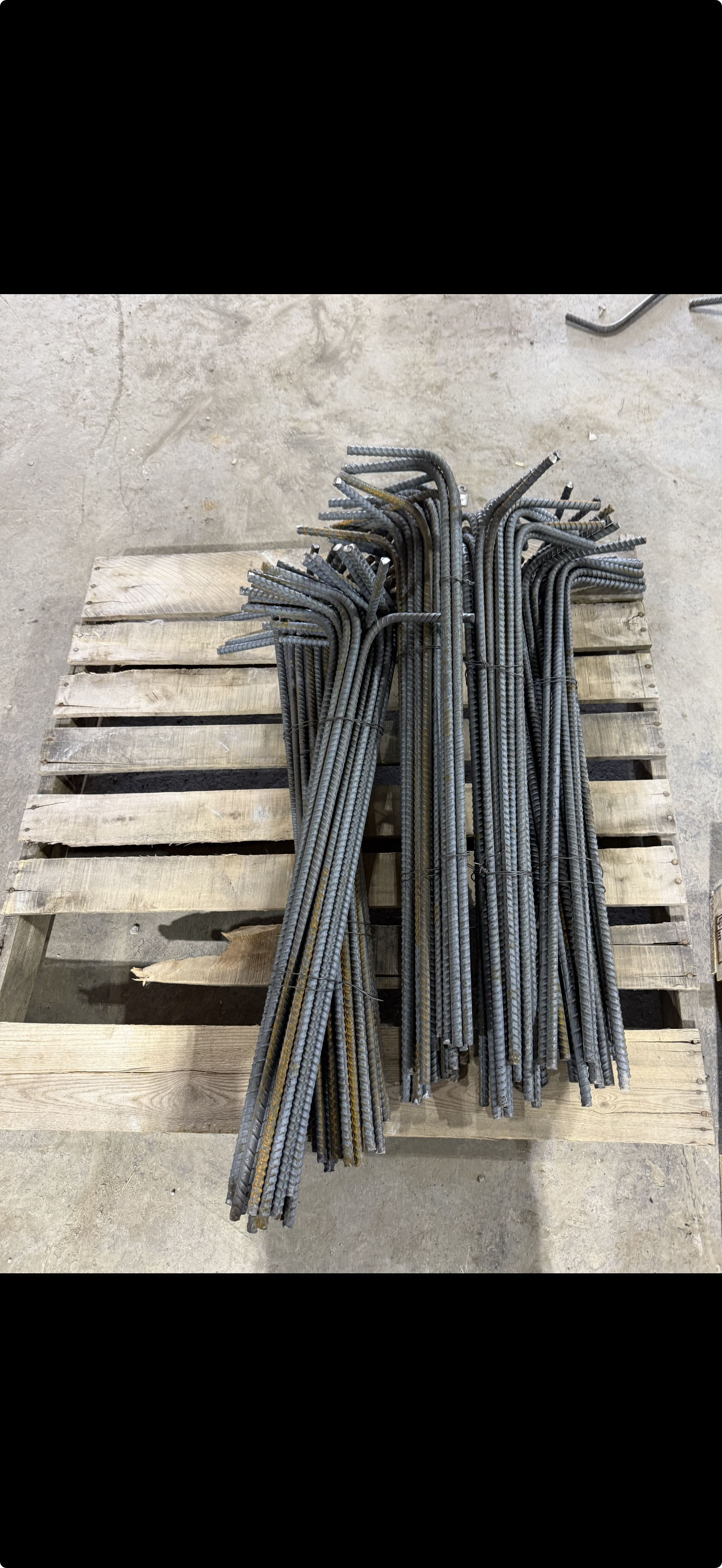Straight rebar stock staged in the yard for concrete reinforcing projects