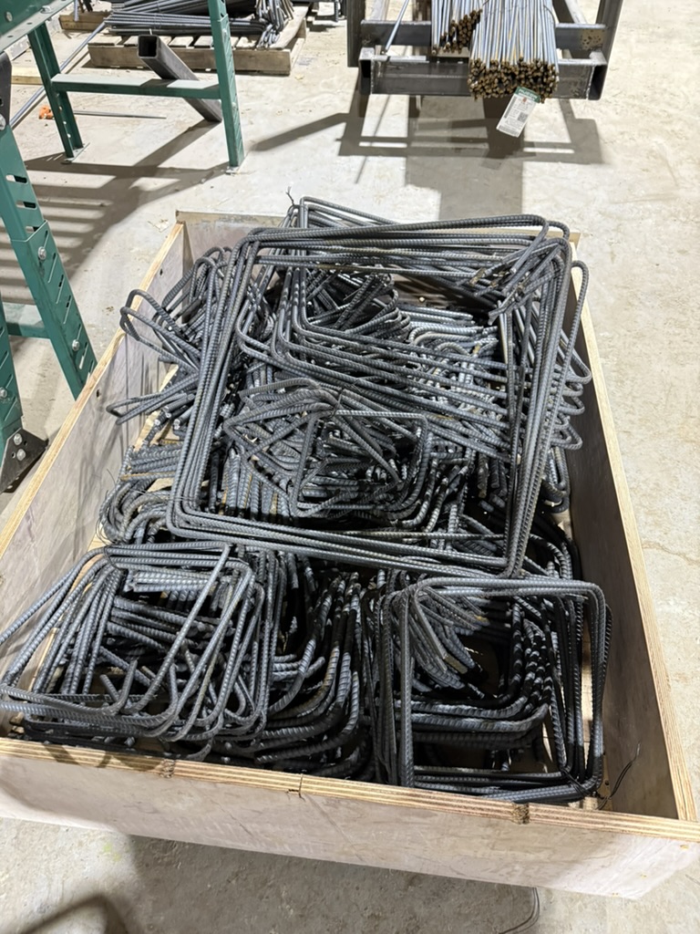 Custom fabricated rebar stirrups in a wooden crate